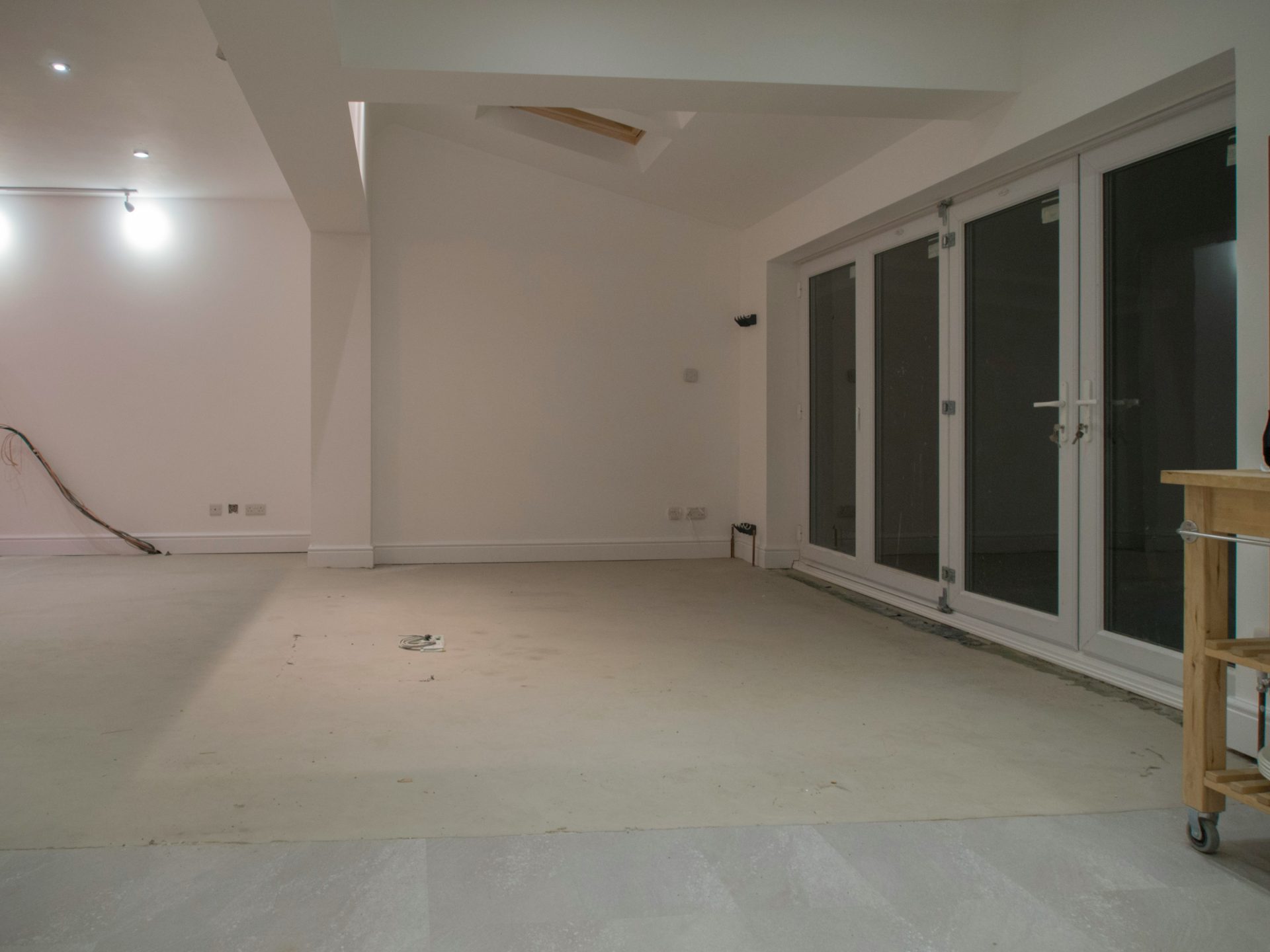 Empty room with white walls and glass doors.
